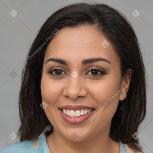 Joyful latino young-adult female with medium  brown hair and brown eyes