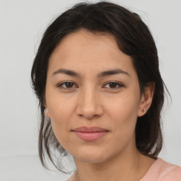 Joyful latino young-adult female with medium  brown hair and brown eyes