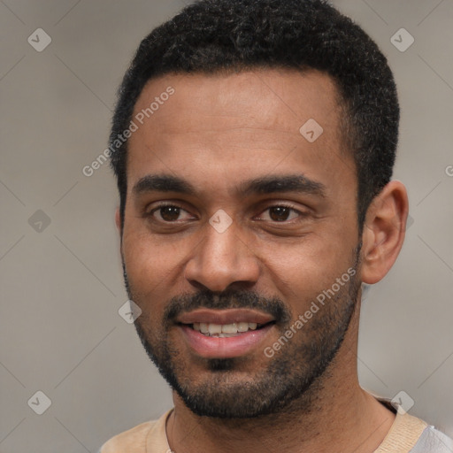 Joyful black young-adult male with short  black hair and brown eyes