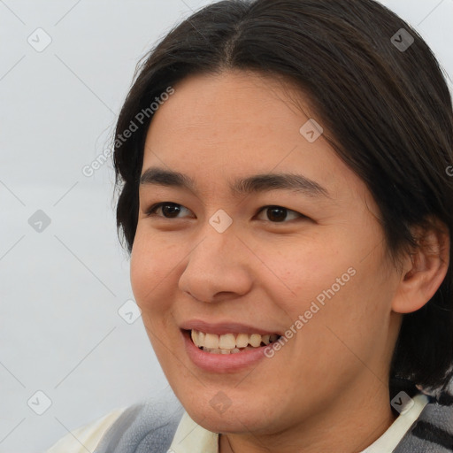 Joyful asian young-adult female with medium  brown hair and brown eyes