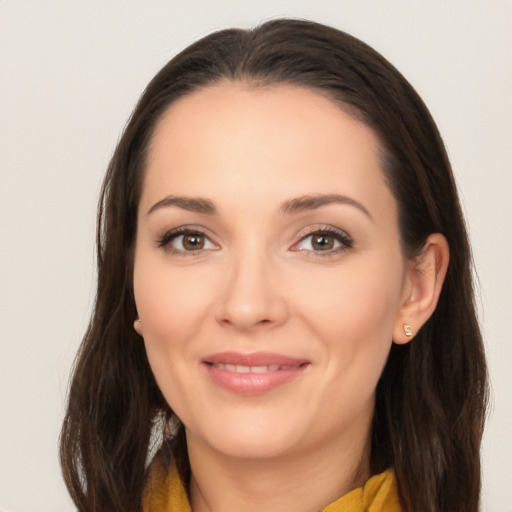 Joyful white young-adult female with long  brown hair and brown eyes