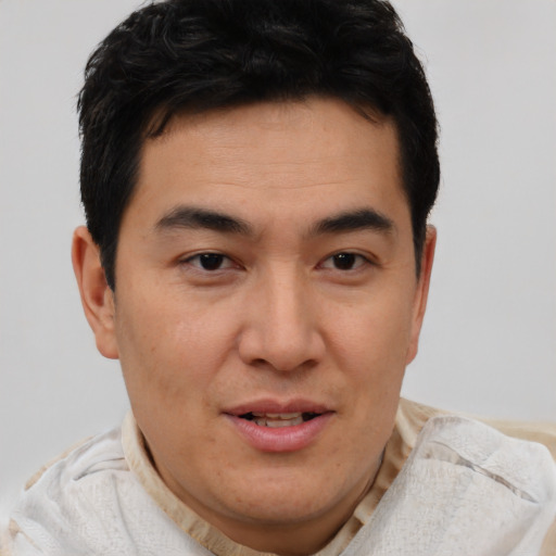 Joyful asian young-adult male with short  brown hair and brown eyes