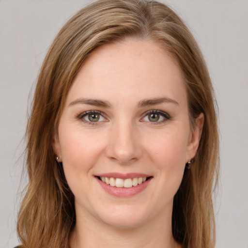 Joyful white young-adult female with long  brown hair and green eyes