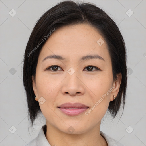 Joyful asian young-adult female with medium  black hair and brown eyes