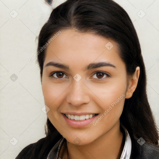 Joyful latino young-adult female with long  brown hair and brown eyes