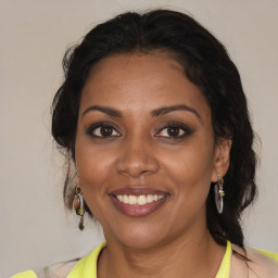 Joyful black adult female with medium  brown hair and brown eyes