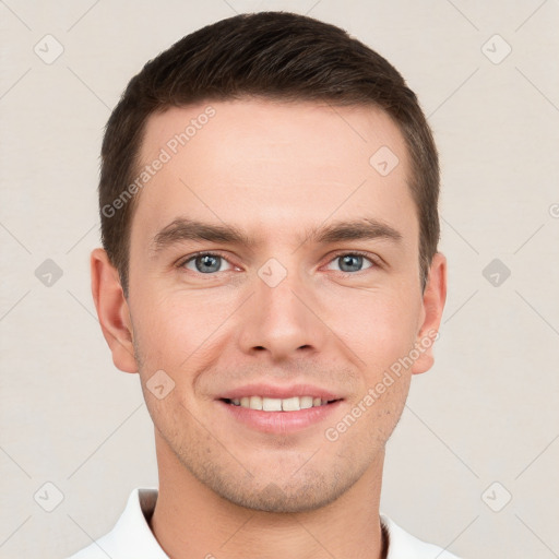 Joyful white young-adult male with short  brown hair and grey eyes