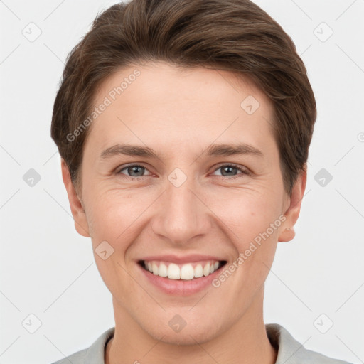 Joyful white young-adult female with short  brown hair and grey eyes