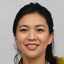 Joyful asian young-adult female with medium  black hair and brown eyes