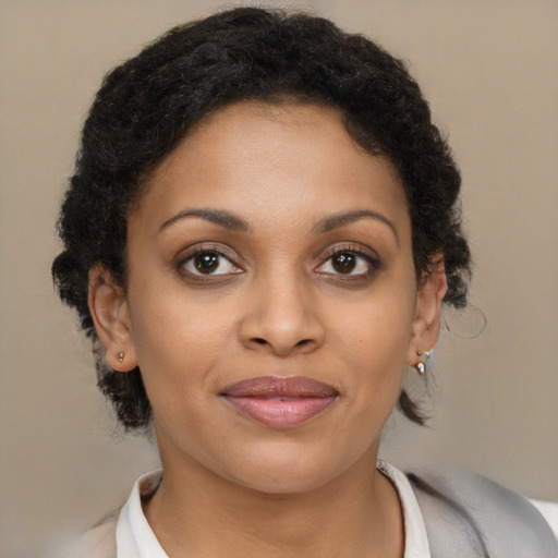 Joyful black young-adult female with medium  brown hair and brown eyes