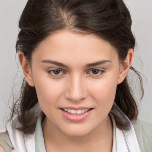 Joyful white young-adult female with medium  brown hair and brown eyes