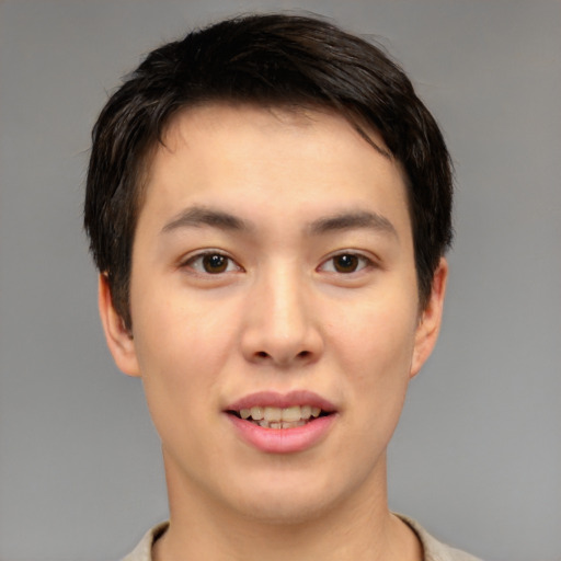 Joyful asian young-adult male with short  brown hair and brown eyes