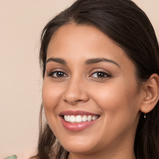 Joyful white young-adult female with long  brown hair and brown eyes