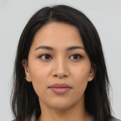 Joyful latino young-adult female with long  brown hair and brown eyes