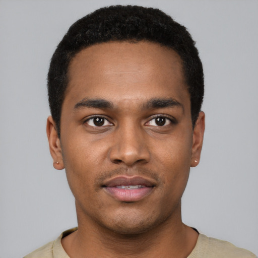 Joyful black young-adult male with short  black hair and brown eyes