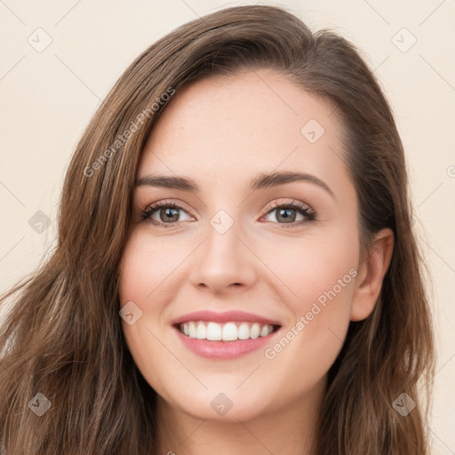 Joyful white young-adult female with long  brown hair and green eyes