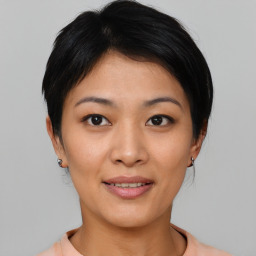 Joyful asian young-adult female with short  brown hair and brown eyes