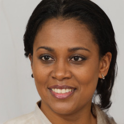 Joyful black adult female with medium  brown hair and brown eyes