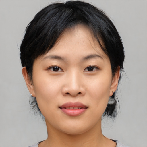 Joyful asian young-adult female with medium  black hair and brown eyes