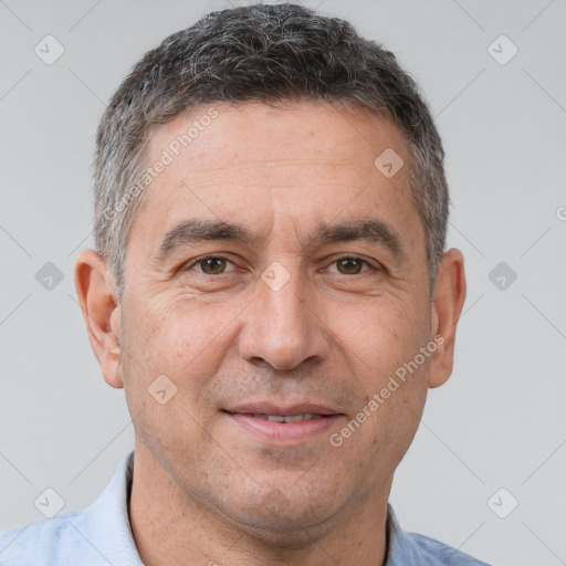 Joyful white adult male with short  brown hair and brown eyes