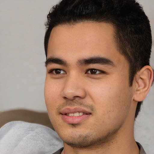 Joyful latino young-adult male with short  brown hair and brown eyes