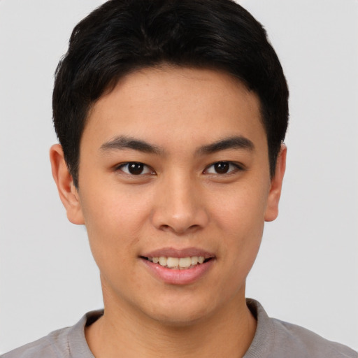 Joyful asian young-adult male with short  black hair and brown eyes