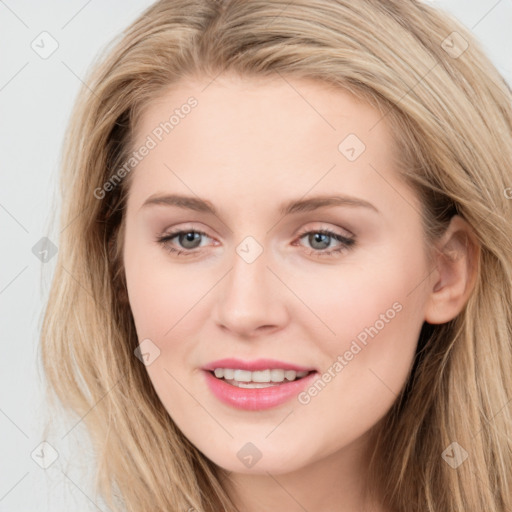 Joyful white young-adult female with long  brown hair and blue eyes