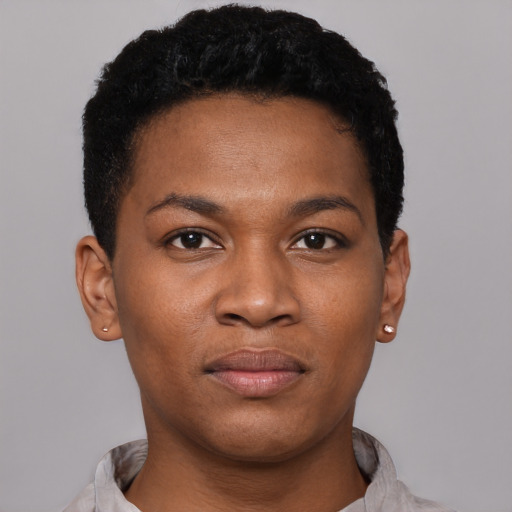 Joyful black young-adult male with short  black hair and brown eyes