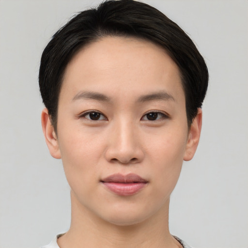 Joyful asian young-adult female with short  brown hair and brown eyes