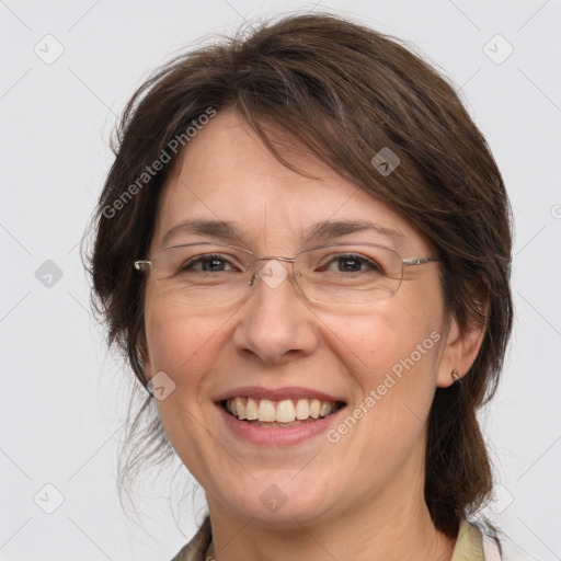 Joyful white adult female with medium  brown hair and grey eyes