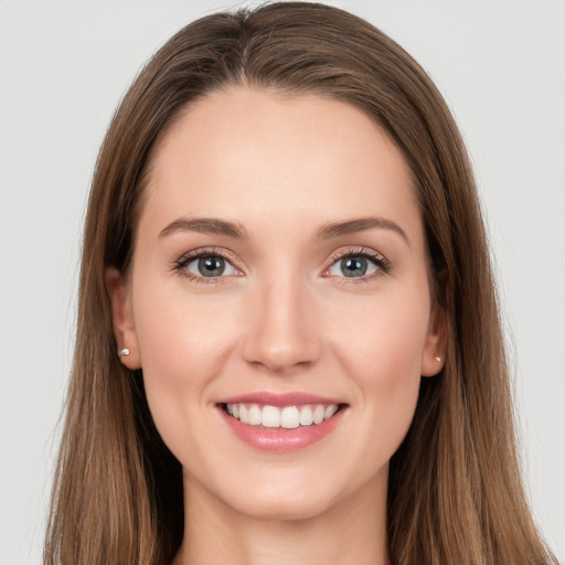 Joyful white young-adult female with long  brown hair and grey eyes