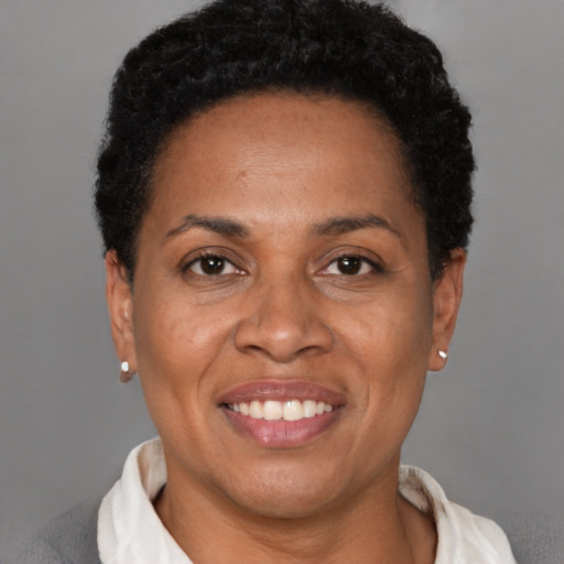 Joyful latino adult female with short  black hair and brown eyes