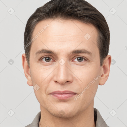 Joyful white adult male with short  brown hair and brown eyes