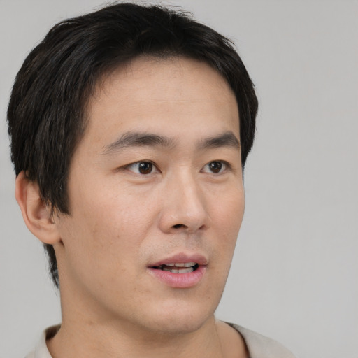 Neutral asian young-adult male with short  black hair and brown eyes