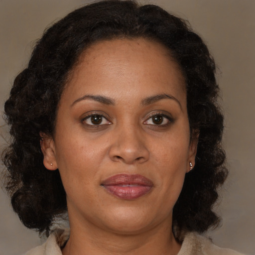 Joyful black adult female with medium  brown hair and brown eyes
