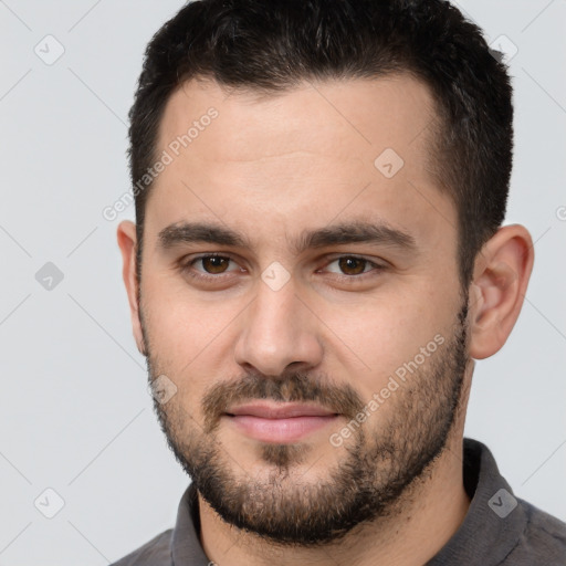 Joyful white young-adult male with short  brown hair and brown eyes