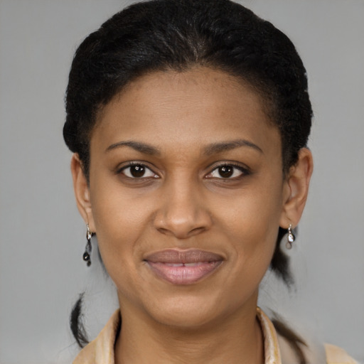 Joyful black young-adult female with short  brown hair and brown eyes