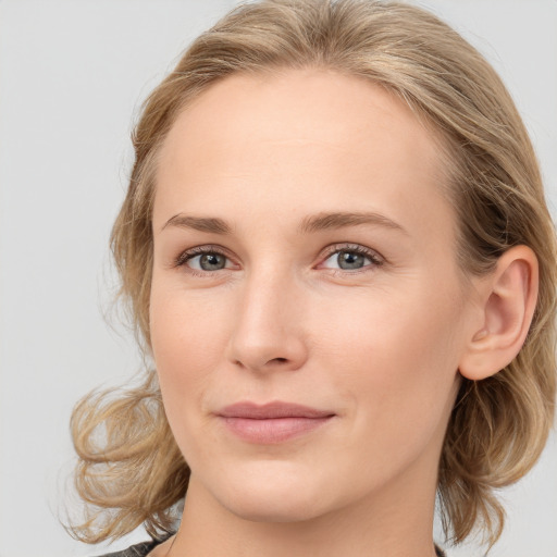 Joyful white young-adult female with medium  brown hair and blue eyes