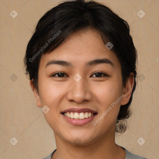 Joyful asian young-adult female with short  brown hair and brown eyes