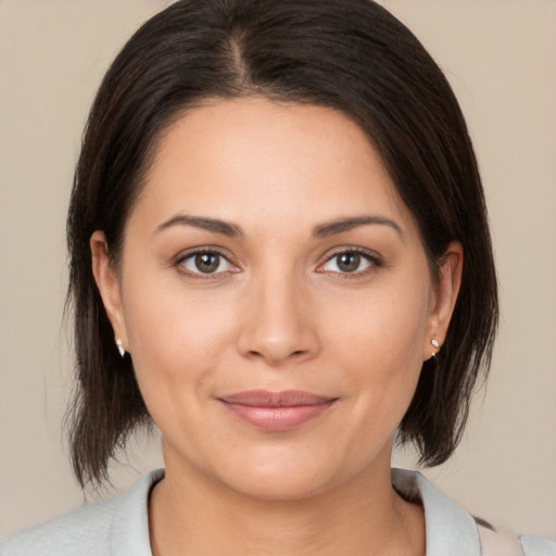 Joyful white young-adult female with medium  brown hair and brown eyes