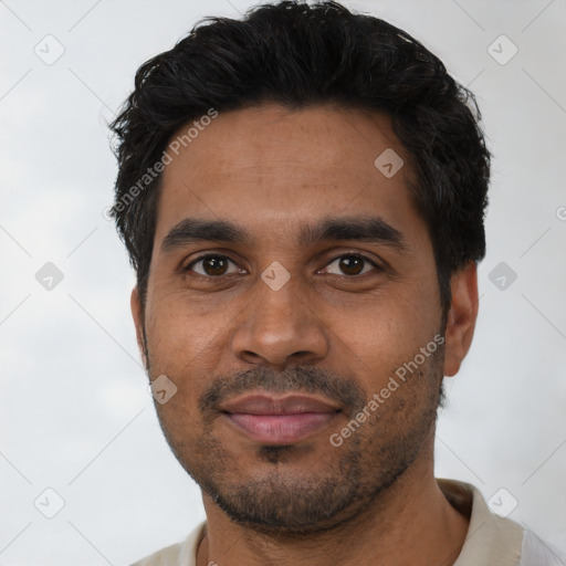 Joyful black young-adult male with short  black hair and brown eyes