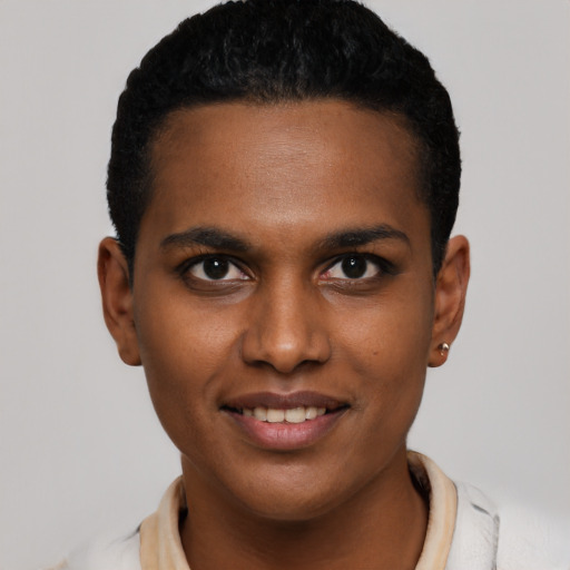 Joyful black young-adult male with short  brown hair and brown eyes