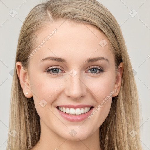 Joyful white young-adult female with long  brown hair and blue eyes