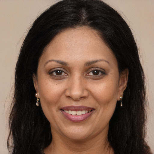 Joyful white adult female with long  brown hair and brown eyes