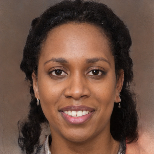 Joyful black adult female with long  black hair and brown eyes