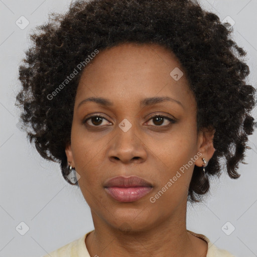 Joyful black adult female with medium  brown hair and brown eyes