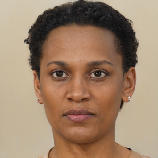 Joyful black adult female with short  brown hair and brown eyes