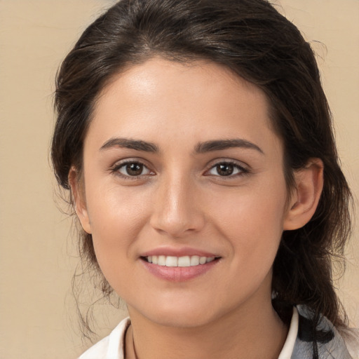 Joyful white young-adult female with medium  brown hair and brown eyes