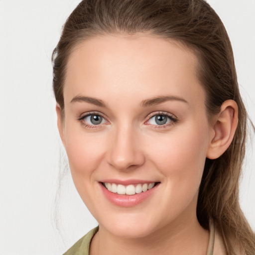 Joyful white young-adult female with long  brown hair and grey eyes