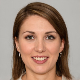 Joyful white young-adult female with medium  brown hair and green eyes